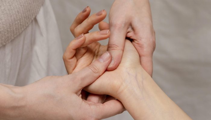 close-up-therapist-massaging-palm